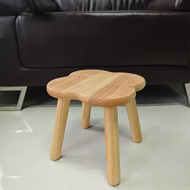 A retro-style creative solid wood clover shoe stool