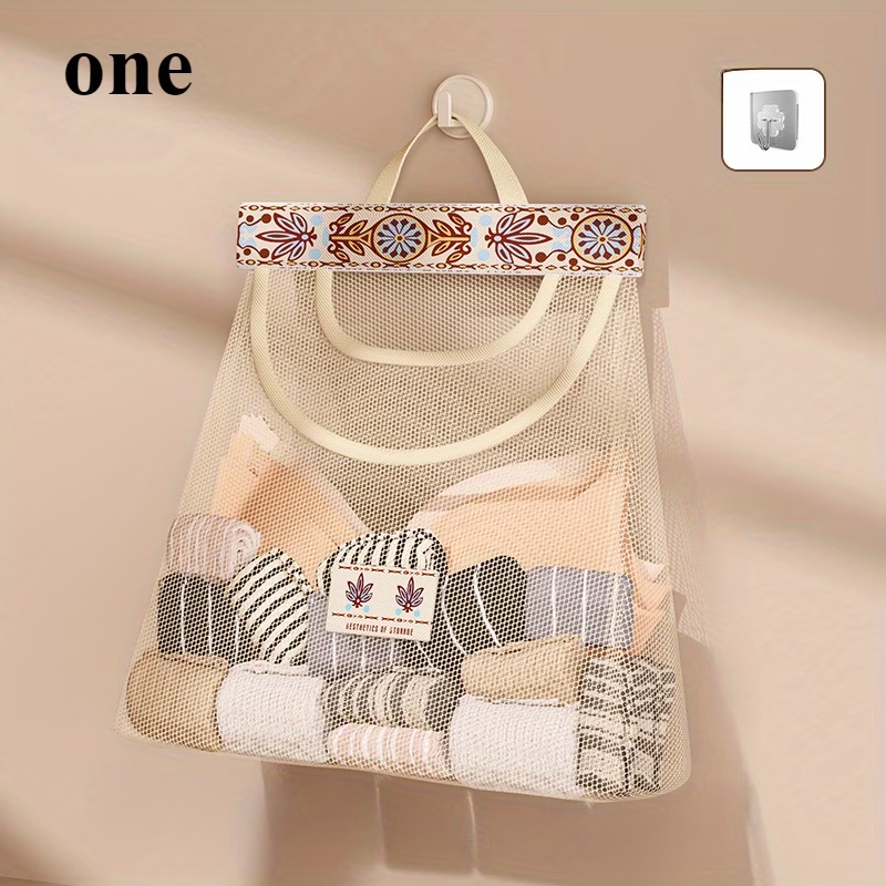 One wall-mounted fabric storage bag with hanging net and hooks.